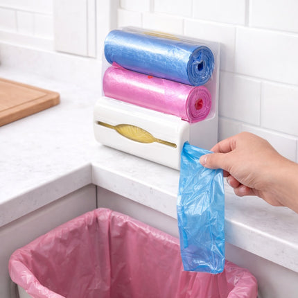 Rolls of blue and pink plastic bags on a holder with a hand taking a blue bag.