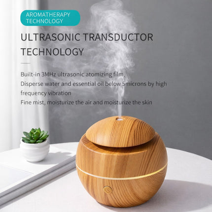 Wooden ultrasonic humidifier with text about aromatherapy technology on a gray background