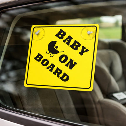Yellow 'Baby on Board' sign on a car window