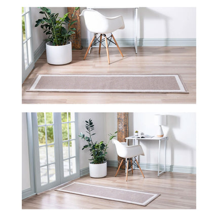 Beige runner rug on a wooden floor with a white chair and plant in a pot.