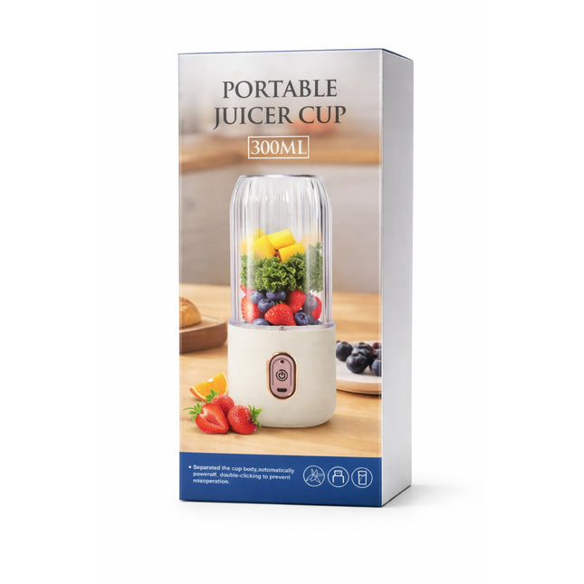 Packaging of a portable juicer cup with fruits and vegetables on a wooden surface.