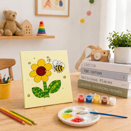 Children's art project with a painted flower and bee on a yellow background, surrounded by art supplies and books.