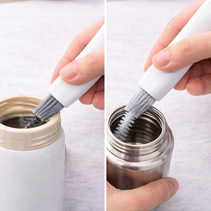 Person cleaning a metal container with a brush on a white background