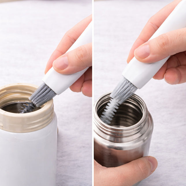 Person cleaning a metal container with a brush on a white background