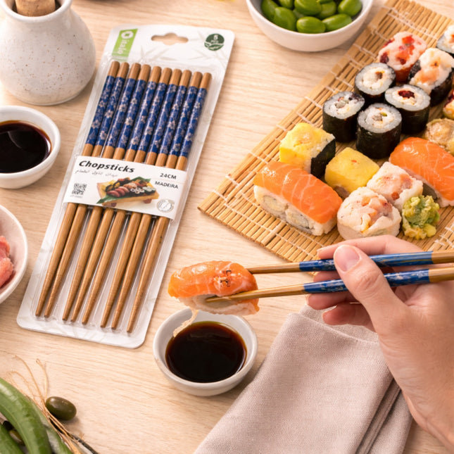 Chopsticks with packaging on a table with sushi and soy sauce