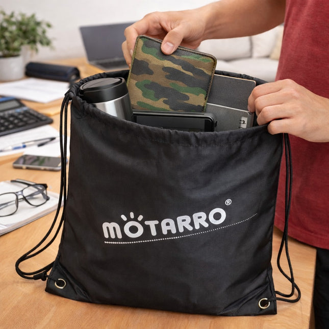 Person organizing items into a black drawstring bag with 'motarro' branding on a desk.