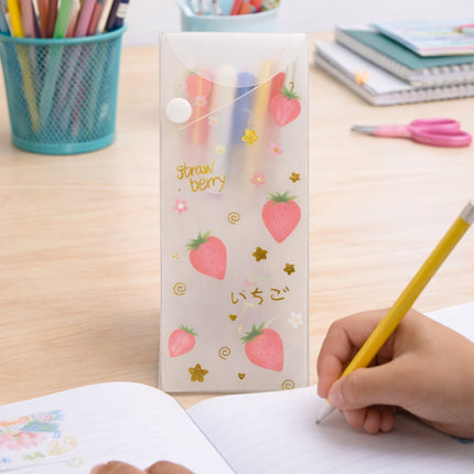 Pencil case with strawberry design on a desk with stationery items
