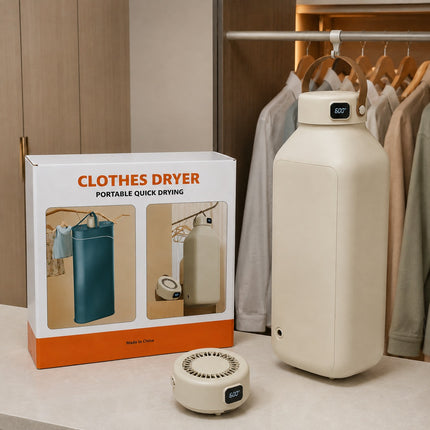 Portable clothes dryer set including a cream-colored portable dryer, its matching retail box, and a small cooling fan, displayed next to a wooden closet wardrobe.