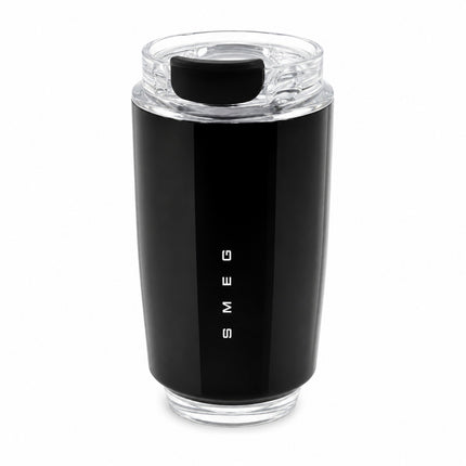A black stainless steel travel tumbler with a clear lid and a vertical white 'SMEG' logo on the front, set against a plain white background.