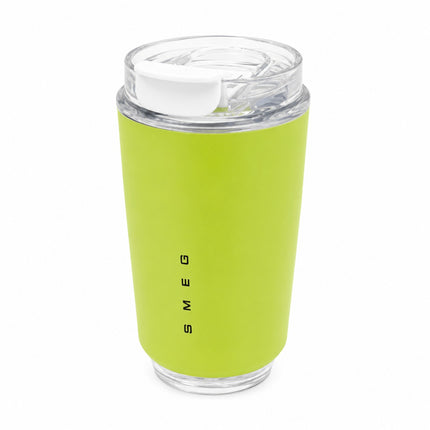 A lime green insulated travel tumbler with a clear lid and white flip-top spout, featuring the vertical black brand name 'SMEG' on the front, set against a plain white background.