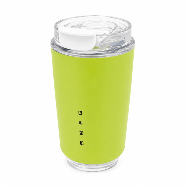 A lime green insulated travel tumbler with a clear lid and white flip-top spout, featuring the vertical black brand name 'SMEG' on the front, set against a plain white background.