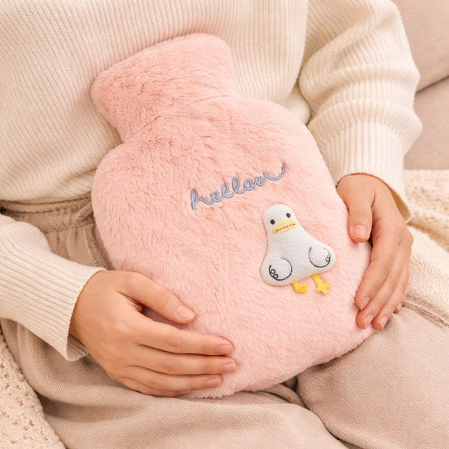 Person holding a pink plush toy with a cartoon character and 'hello' text.