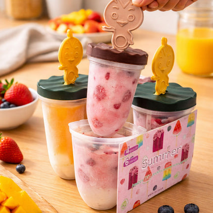 Ice cream popsicles in molds with a 'Summer' branded container on a wooden table.