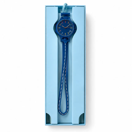 A blue analog wristwatch with a matching blue strap and white stitching, presented inside a light blue rectangular gift box on a white background.