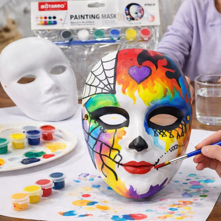 Colorful mask being painted with art supplies on a table