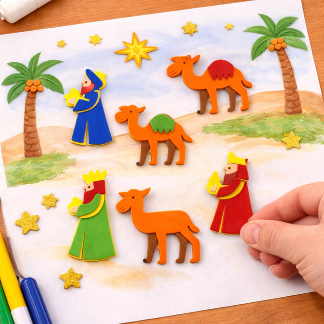 Colorful nativity scene cutouts on a paper background with a hand interacting with them.