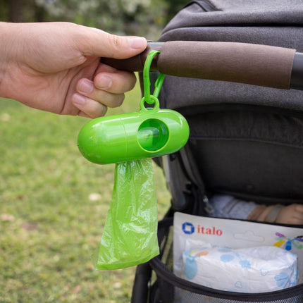 Green plastic bag holder attached to a stroller with a blurred background