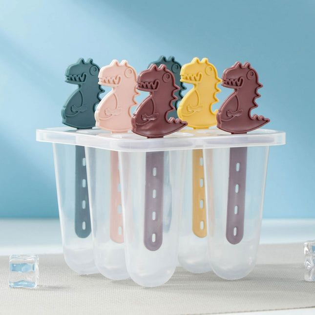 Set of dinosaur-shaped ice cream molds in various colors on a white surface with a blue gradient background.