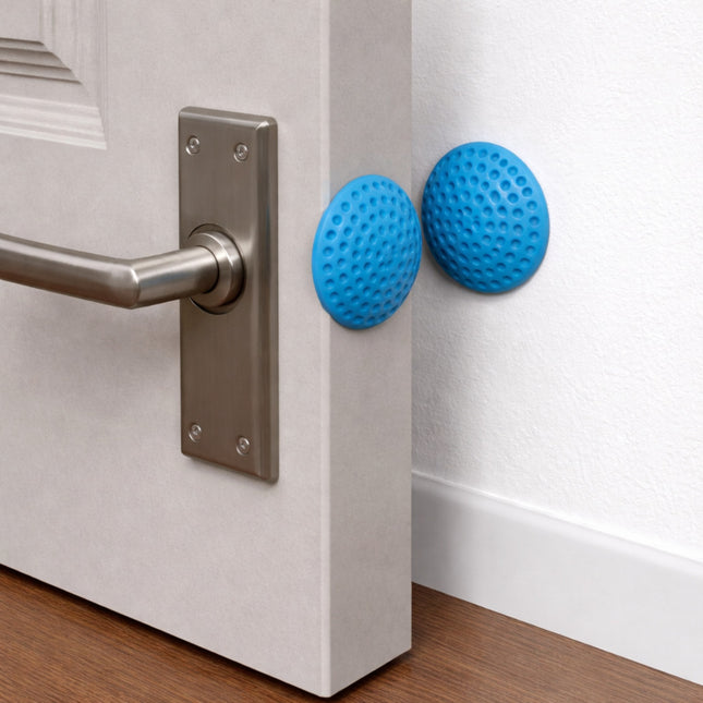 Blue door stoppers on a white door next to a silver handle.