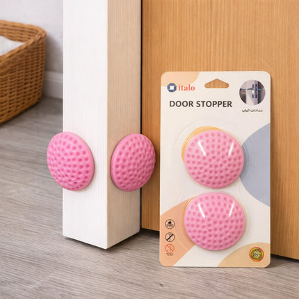 Pink door stopper with packaging on a wooden floor