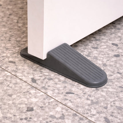 Black door stopper against a tiled floor