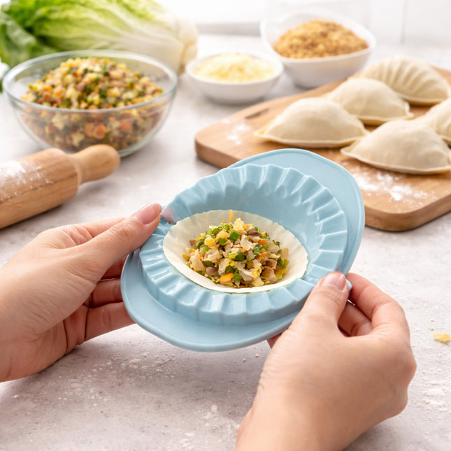 Person using a blue dough press to shape dumplings with ingredients in the background.