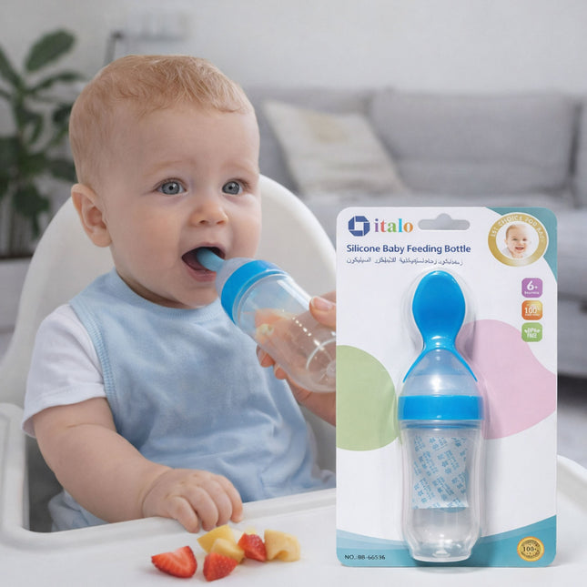 Baby drinking from a blue and clear silicone baby feeding bottle with packaging in the foreground.