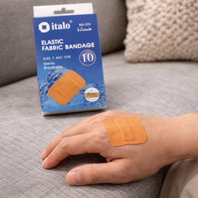 Italo elastic fabric bandage package on a couch with a bandage on a hand