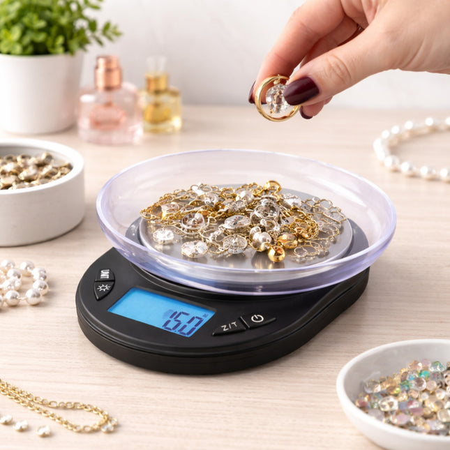 Person weighing jewelry on a digital scale with a blurred background