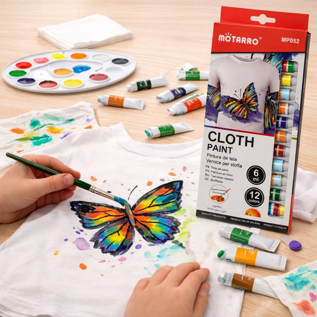Person painting a butterfly design on a t-shirt with Motarro cloth paint set.