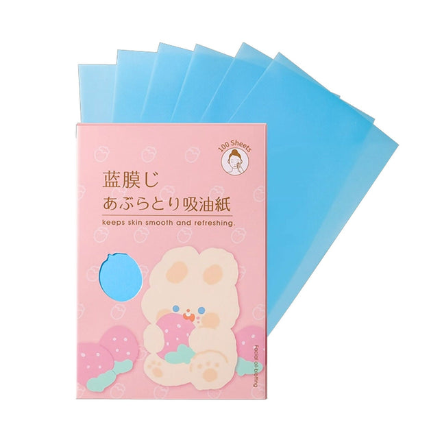 Pack of blue oil-absorbing sheets with a pink packaging featuring a cartoon character on a white background.