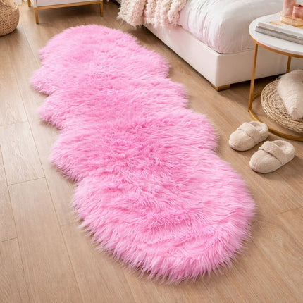 Pink shaggy rug on a wooden floor in a living room setting.