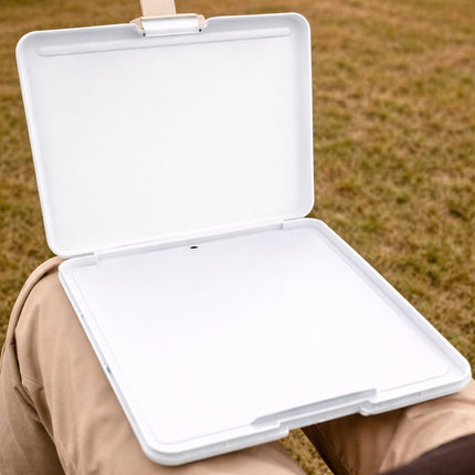 White plastic container held by a person with grass in the background