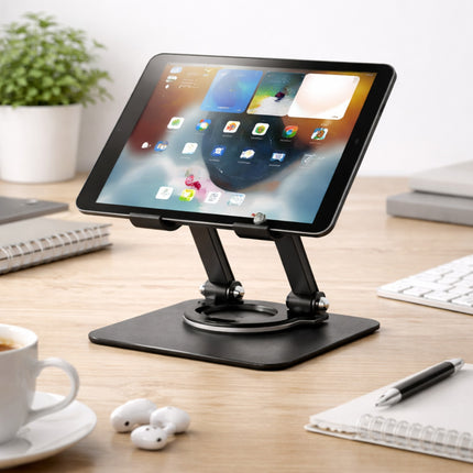 Tablet on a stand on a desk with a cup of coffee, earbuds, and a keyboard in the background.
