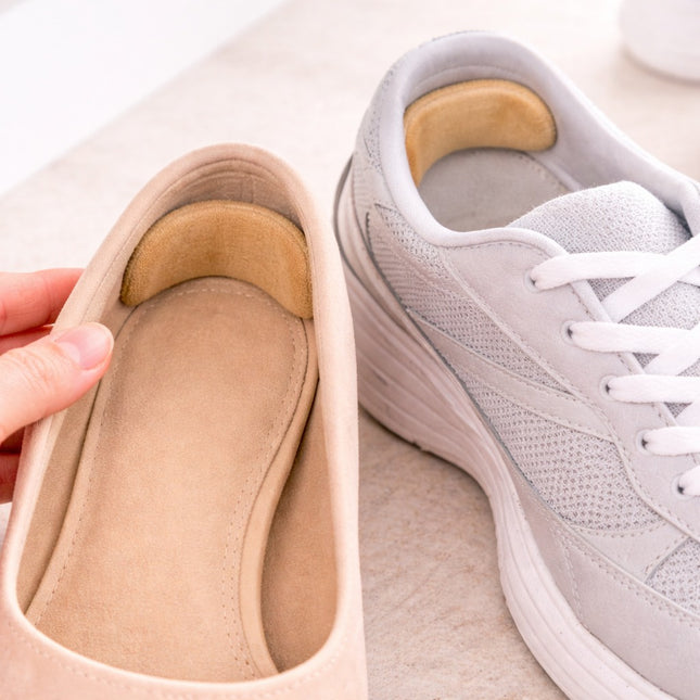 Beige shoe insert next to a gray sneaker on a light background