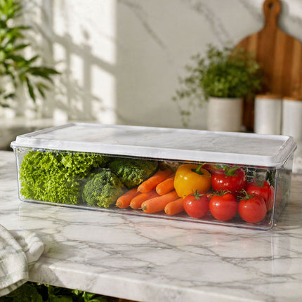 Clear container with vegetables on a marble surface
