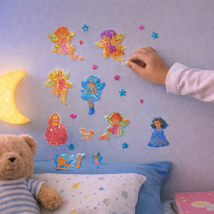 Colorful fairy wall stickers on a child's bedroom wall with a teddy bear and nightlight.