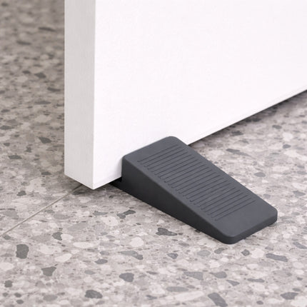 Black door stopper on a gray floor