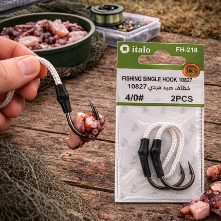 Fishing hook with bait and italo branded packaging on a wooden surface