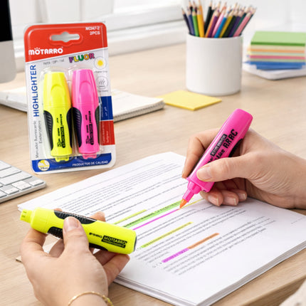 Two highlighters being used on a document with packaging and stationery items in the background.