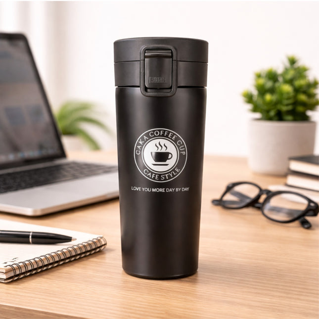 Black coffee cup with 'Cafe Style' branding on a desk with laptop, glasses, and plant.
