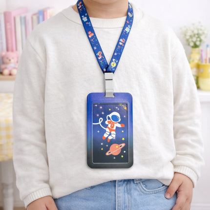Person wearing a white sweater with a colorful ID holder on a lanyard featuring an astronaut design.