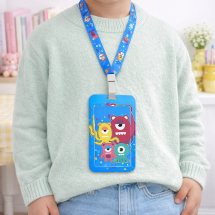 Child wearing a colorful card holder with cartoon monsters on a blue lanyard.