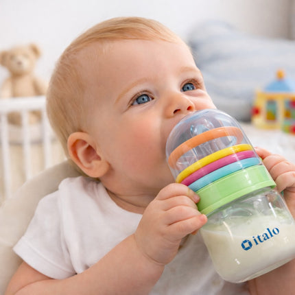 Baby holding a colorful bottle with 'italo' branding