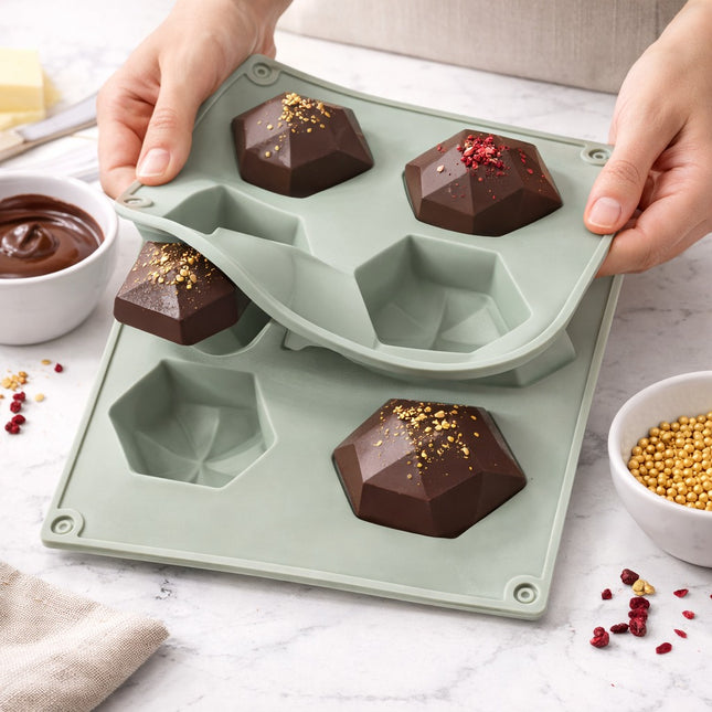 Silicone mold with diamond-shaped chocolate pieces on a light surface