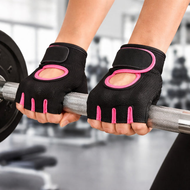 Person wearing black and pink gloves holding a barbell in a gym setting