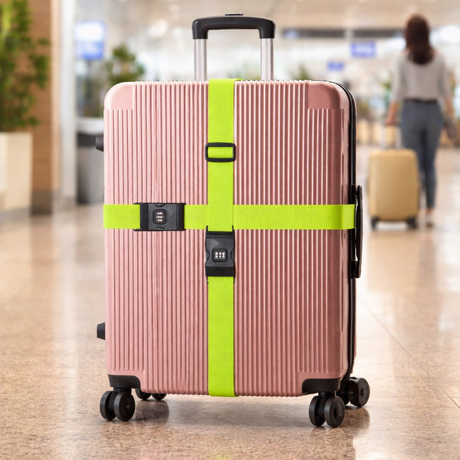Pink suitcase with a green strap in an airport setting