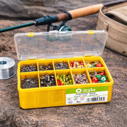 Yellow fishing tackle box with various fishing accessories on a wooden surface, with a fishing rod and reel in the background.