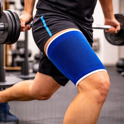 Person lifting weights with a blue knee brace on in a gym setting