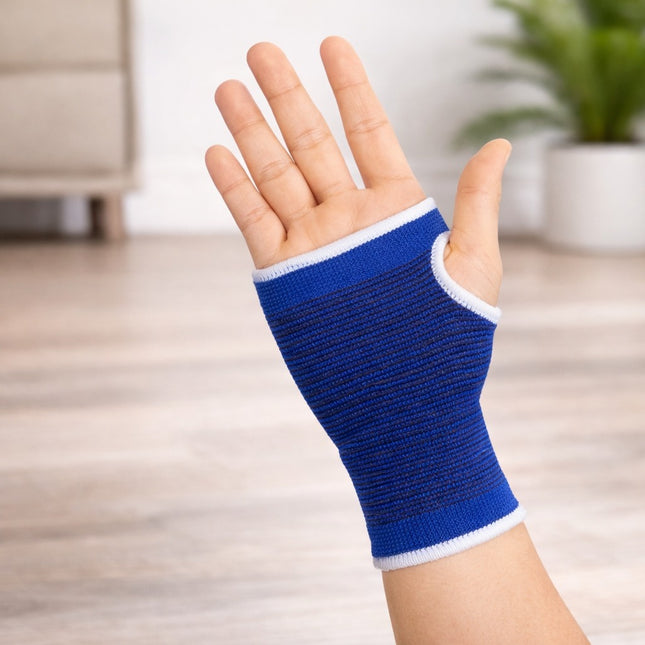 Hand wearing a blue wrist support with a blurred indoor background